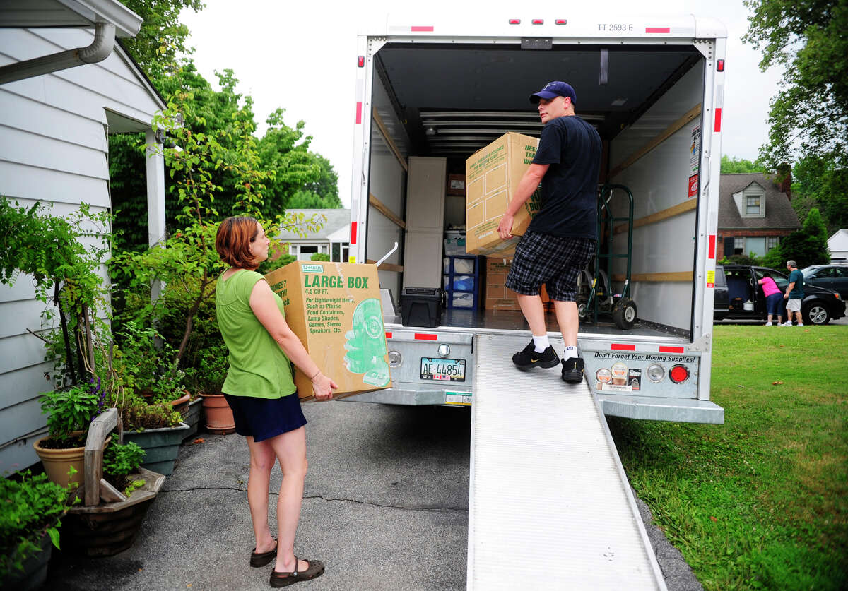 In this July 13, 2012, file photo, people load a U-Haul truck with boxes while they prepare to move in York, Pa. Many have had to reconsider their living situation because of the pandemic. Before you decide to relocate, make a budget to account for moving costs and the cost of living in your new location. (Chris Dunn/York Daily Record via AP, File)