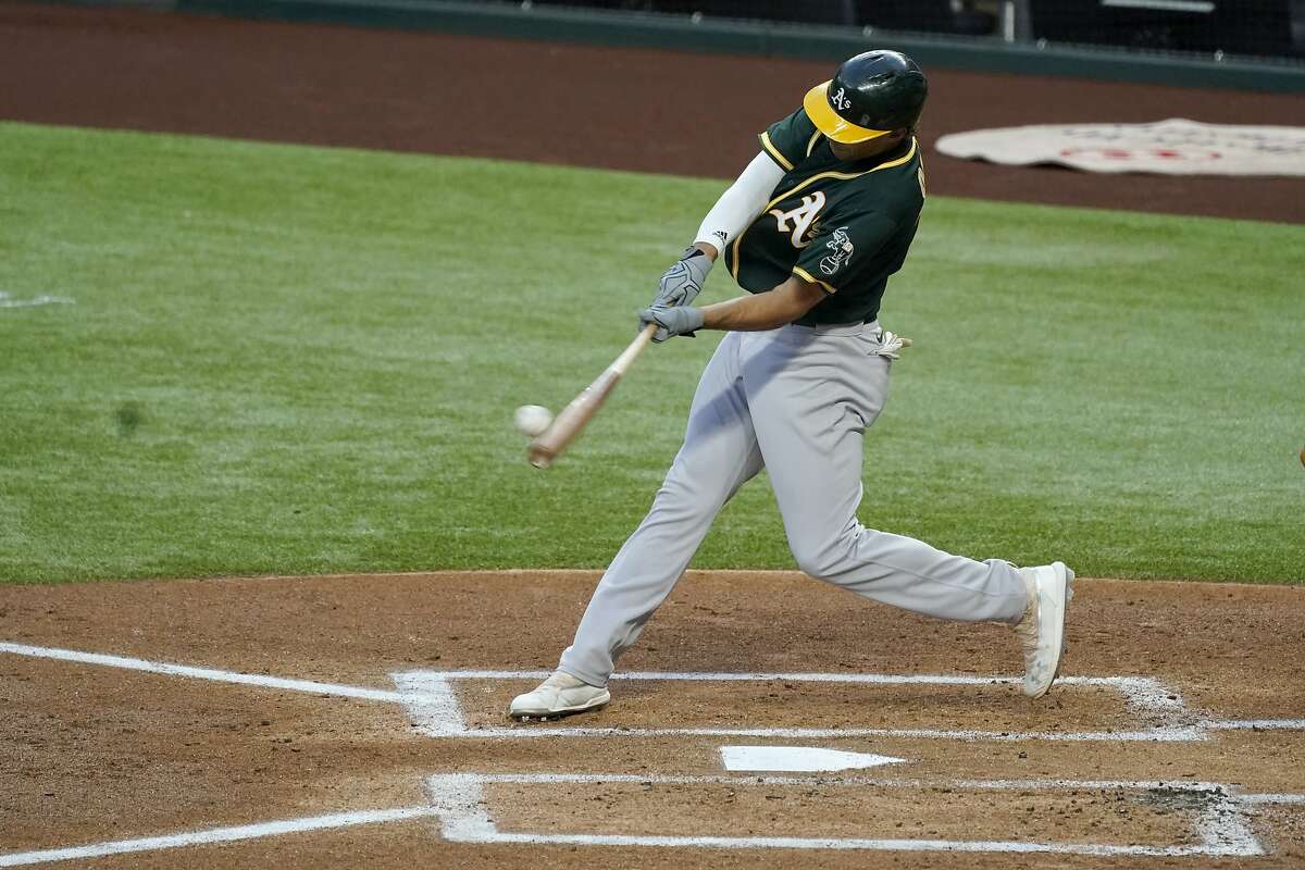 Oakland Athletics' Matt Olson connects on a pitch from Texas Rangers' Luis Garcia for a grand slam in the first inning of a baseball game in Arlington, Texas, Friday, Sept. 11, 2020. (AP Photo/Tony Gutierrez)