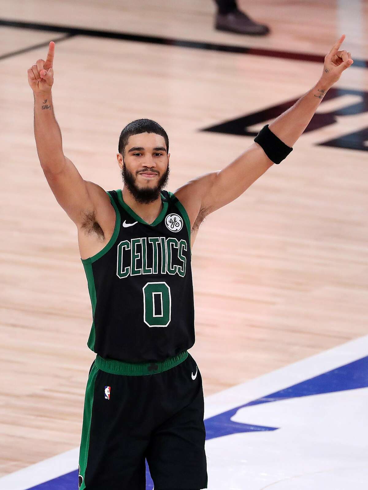 LAKE BUENA VISTA, FLORIDA - SEPTEMBER 11: Jayson Tatum #0 of the Boston Celtics reacts after their win against the Toronto Raptors in Game Seven of the Eastern Conference Second Round during the 2020 NBA Playoffs at AdventHealth Arena at the ESPN Wide World Of Sports Complex on September 11, 2020 in Lake Buena Vista, Florida. NOTE TO USER: User expressly acknowledges and agrees that, by downloading and or using this photograph, User is consenting to the terms and conditions of the Getty Images License Agreement. (Photo by Michael Reaves/Getty Images)