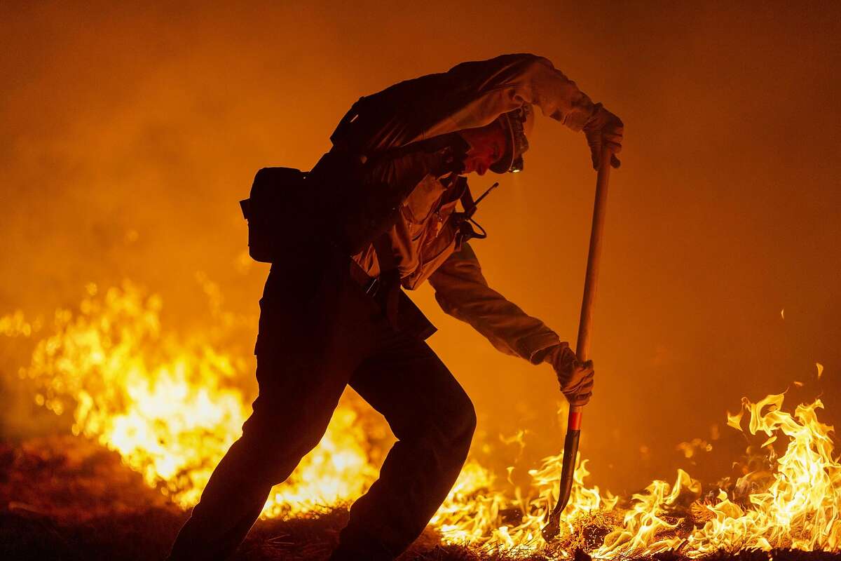 MONROVIA, CA - SEPTEMBER 11: Los Angeles County firefighters, using only hand tools, keep fire from jumping a fire break at the Bobcat Fire in the Angeles National Forest on September 11, 2020 north of Monrovia, California. California wildfires that have already incinerated a record 2.3 million acres this year and are expected to continue till December. The Bobcat Fire has grown to more than 26,000 acres. (Photo by David McNew/Getty Images)