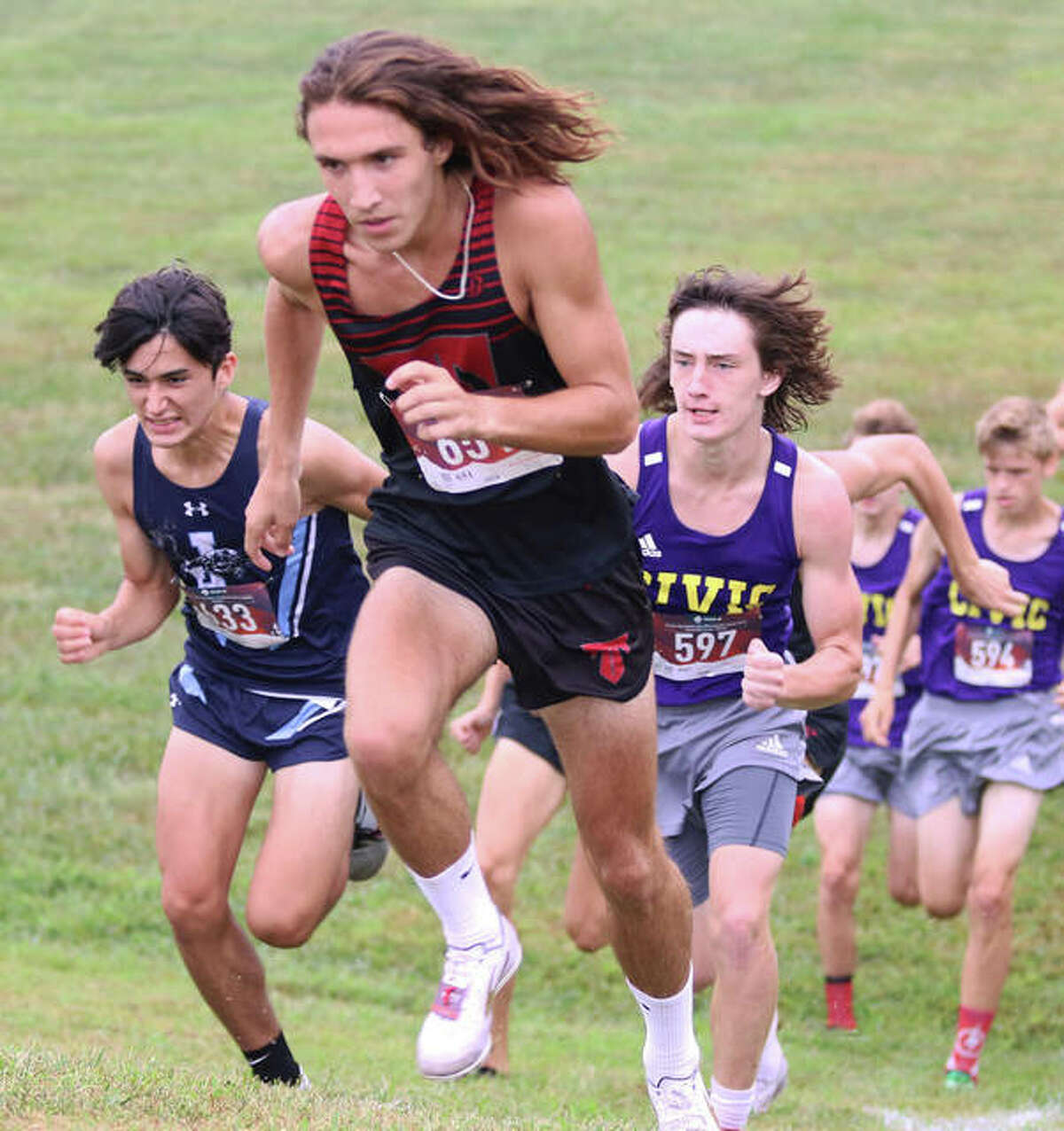 Triad’s Blake Bleier is first up the first hill ahead of Jersey’s Cole Martinez (left) and CM’s Aslan Henderson (597) in Saturday’s Pre-MVC Meet in Troy. Bleier finished third in the race, with Martinez sixth and Henderson 13th.