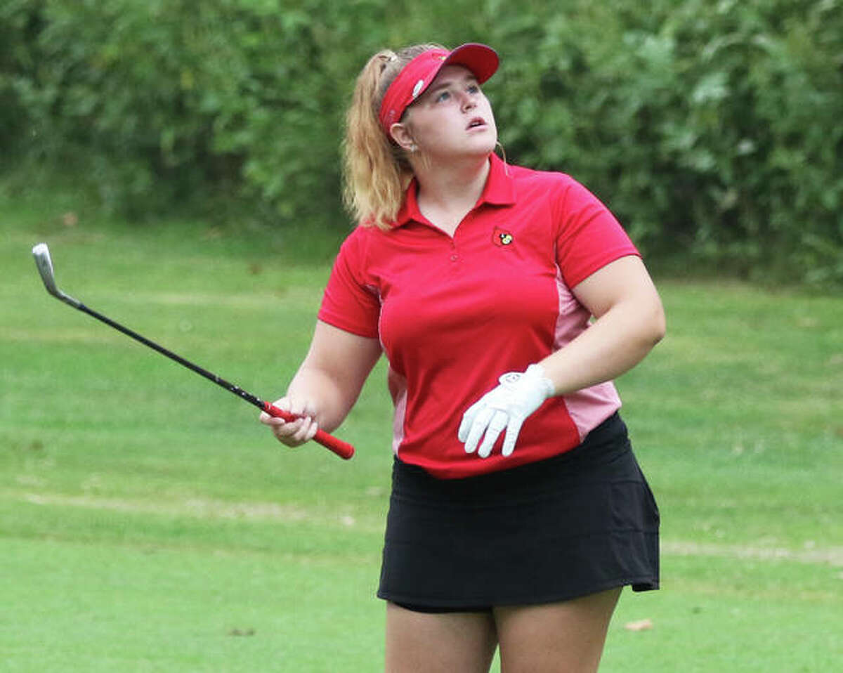 Alton’s Riley Kenney watches her second shot on hole No. 1 Saturday at the Alton Classic at Rolling Hills in Godfrey. Kenney shot a season-best 79 for the Redbirds.