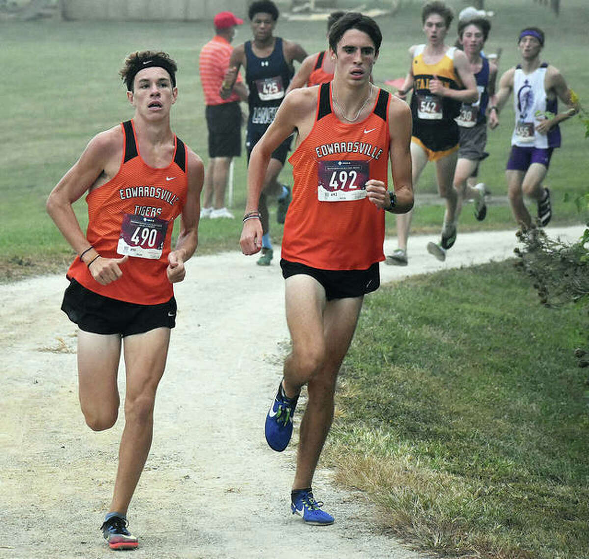 Edwardsville’s Ryan Watts (right) and Geordan Patrylak lead a group of runners at Saturday’s Belleville West Invite.