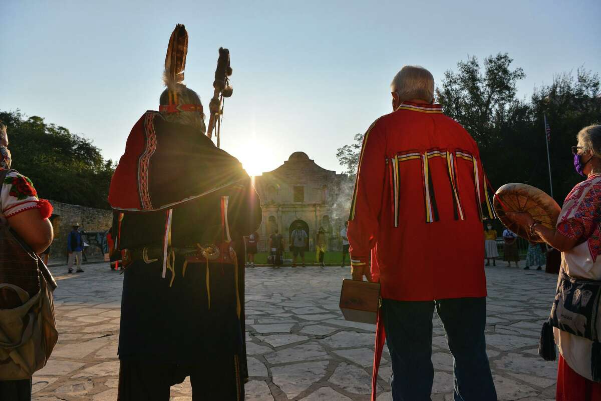 Members of the Tap Pilam Coahuiltecan Nation pause in silence Saturday, Sept. 12, 2020, during this year’s sunrise ceremony in front of the Alamo to honor ancestors buried at the Alamo.