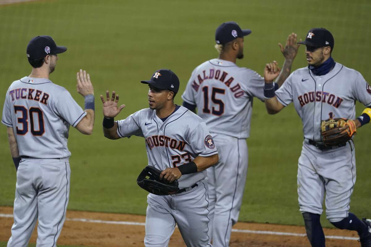The Houston Astros celebrate a 7-5 win over the Los Angeles Dodgers in a baseball game at Dodger Stadium on Saturday, Sept. 12, 2020, in Los Angeles. (AP Photo/Ashley Landis)