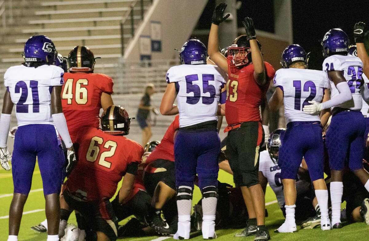 Caney Creek linebacker Samuel Gallaga (43) signs for a touchdown after Caney Creek running back Spencer Brandon (22) crossed the line during a District 8-5A (Div. I) game Thursday, Sept. 26, 2019 at Woodforest Bank Stadium in Shenandoah.