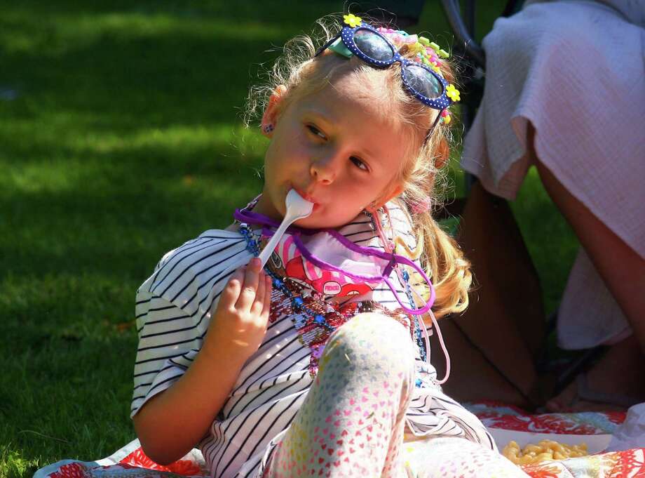 Emma Carlucci, 6, of Easton, enjoys mac and cheese from DrewbaQ food truck during the 1st Annual Easton Town Party on the grounds of Ashlar-Aspetuck Masonic Lodge 142 in Easton, Conn., on Saturday Sept. 12, 2020. Easton held the party to celebrate its 175th birthday. Photo: Christian Abraham / Hearst Connecticut Media / Connecticut Post