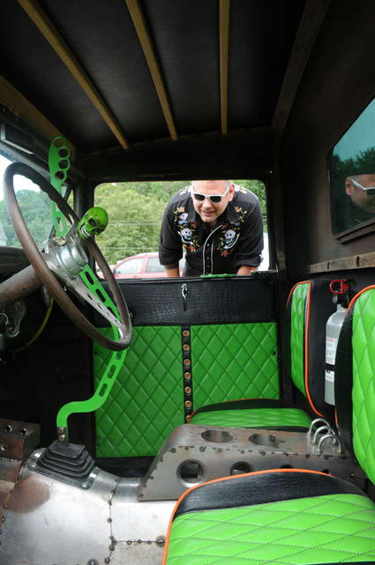 Joe Kozuszek of Belleville admires the interior of an entry in Saturday’s Rat Rod Show in Grafton.
