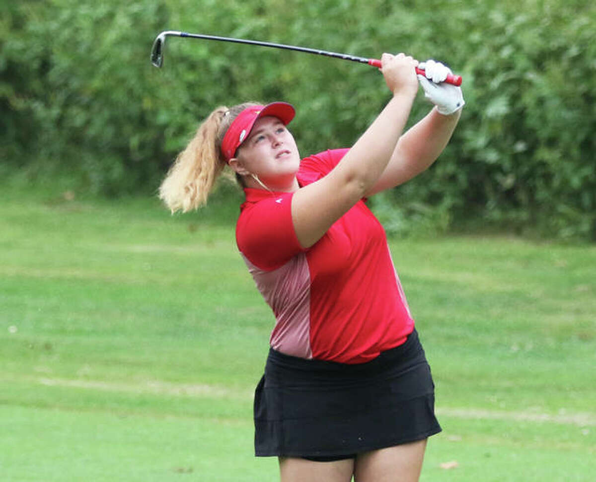 Alton’s Riley Kenney watches her shot on the first hole Saturday in the Alton Classic at Rolling Hills golf course in Godfrey. Kenney shot a career-low 79 to place seventh in the tourney.