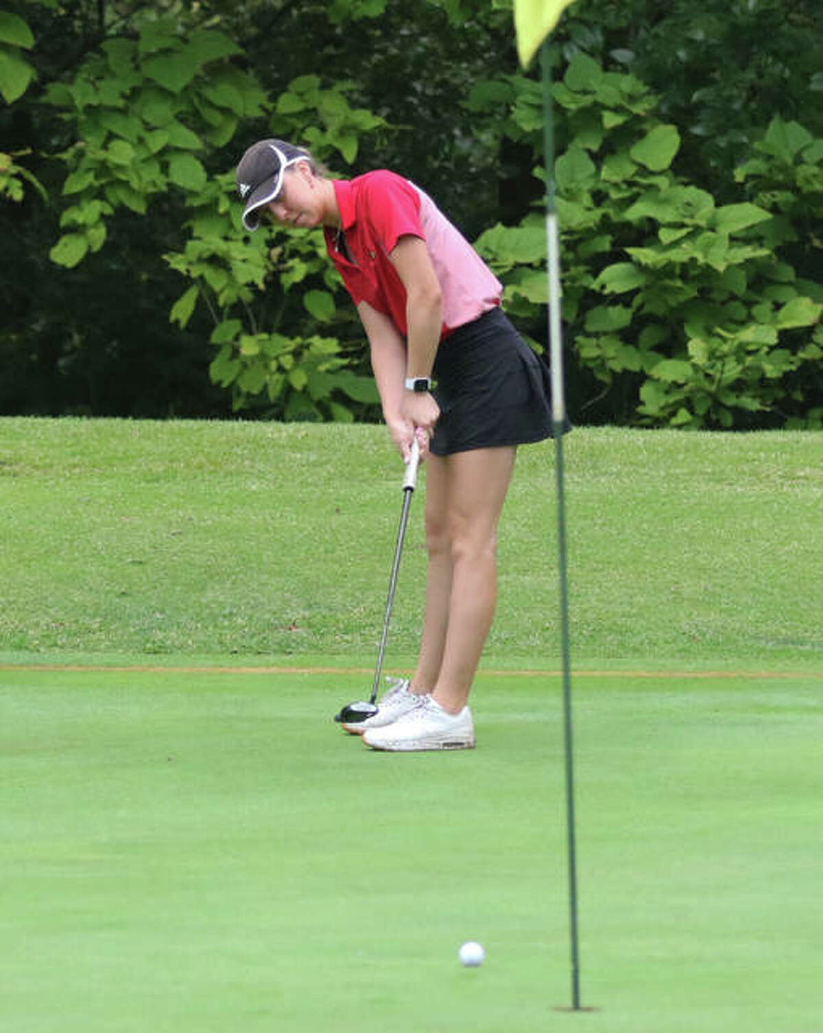 Alton’s Natalie Messinger tracks her putt on hole No. 1 at Rolling Hills in Saturday’s Alton Classic. Messinger placed third in the tourney at 76.