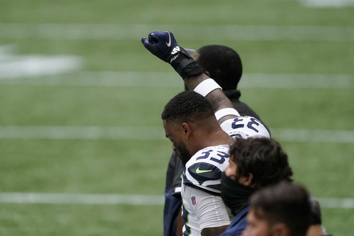 Seattle Seahawks strong safety Jamal Adams (33) participates in the national anthem before the first half of an NFL football game against the Atlanta Falcons, Sunday, Sept. 13, 2020, in Atlanta. (AP Photo/John Bazemore)