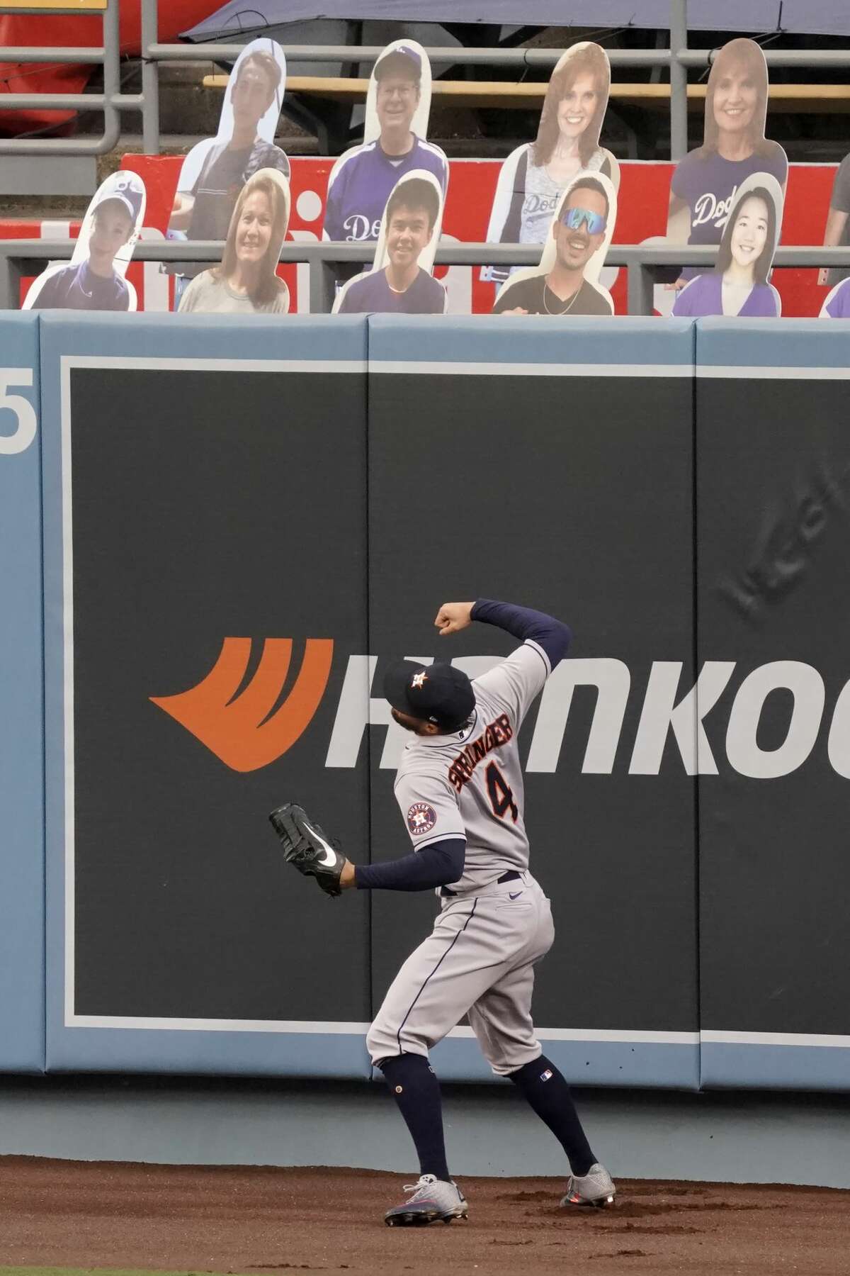 Houston Astros right fielder George Springer reacts as he misses the ball for a two-run home run by Los Angeles Dodgers' Mookie Betts during the fifth inning of a baseball game in Los Angeles, Sunday, Sept. 13, 2020. (AP Photo/Alex Gallardo)
