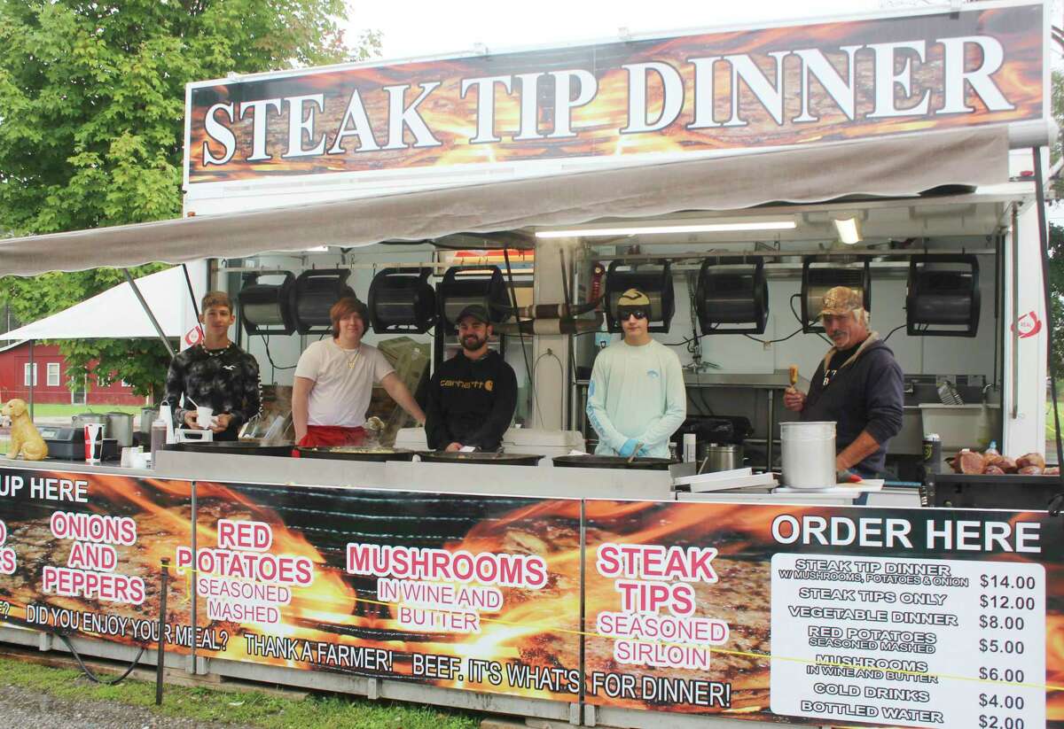 Steak vendors prepared meals for locals during a fair food event Saturday. Other food served included ice cream, cotton candy, lemonade, funnel cakes and more. More photos, 2A. (Pioneer photo/Catherine Sweeney)
