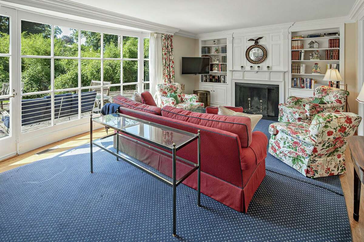 In the living room there is a fireplace flanked by built-in bookshelves, and an oversized bay window looks over the patio. Late in 2014 the current owners started a renovation project and they completed an additional, smaller renovation in 2017. Those projects gave this house a long list of new features including the updated kitchen and baths, expansive first floor master bedroom and master bath with limestone flooring, walk-in closet, mudroom, paved driveway, and hardwood flooring in the kitchen, back hallway and mudroom. A new dining room area was created and it features a skylight.