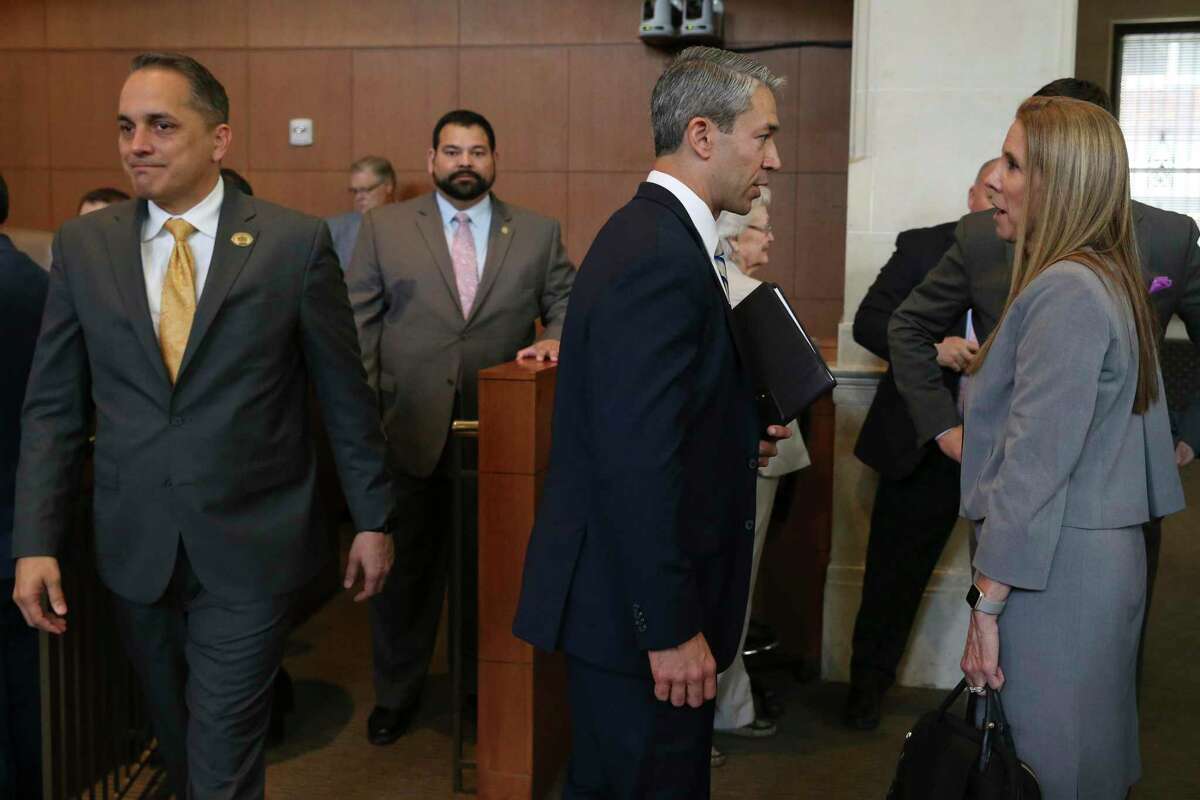 San Antonio Mayor Ron Nirenberg, center, and City Council member Greg Brockhouse, left, mingle with the public before the start of a regular council meeting, Thursday, April 18, 2019. Brockhouse proposed revisiting a contract that excluded Chick-fil-A restaurant from operating at the San Antonio International Airport. The council voted against the move.