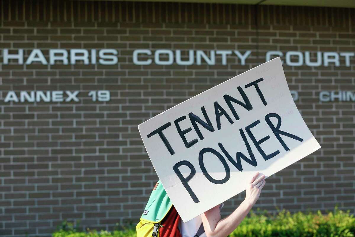 Demonstrators pass the Harris County Courthouse during a protest regarding evictions going on at the court, 6000 Chimney Rock Rd., Friday, Aug. 21, 2020, in Houston.
