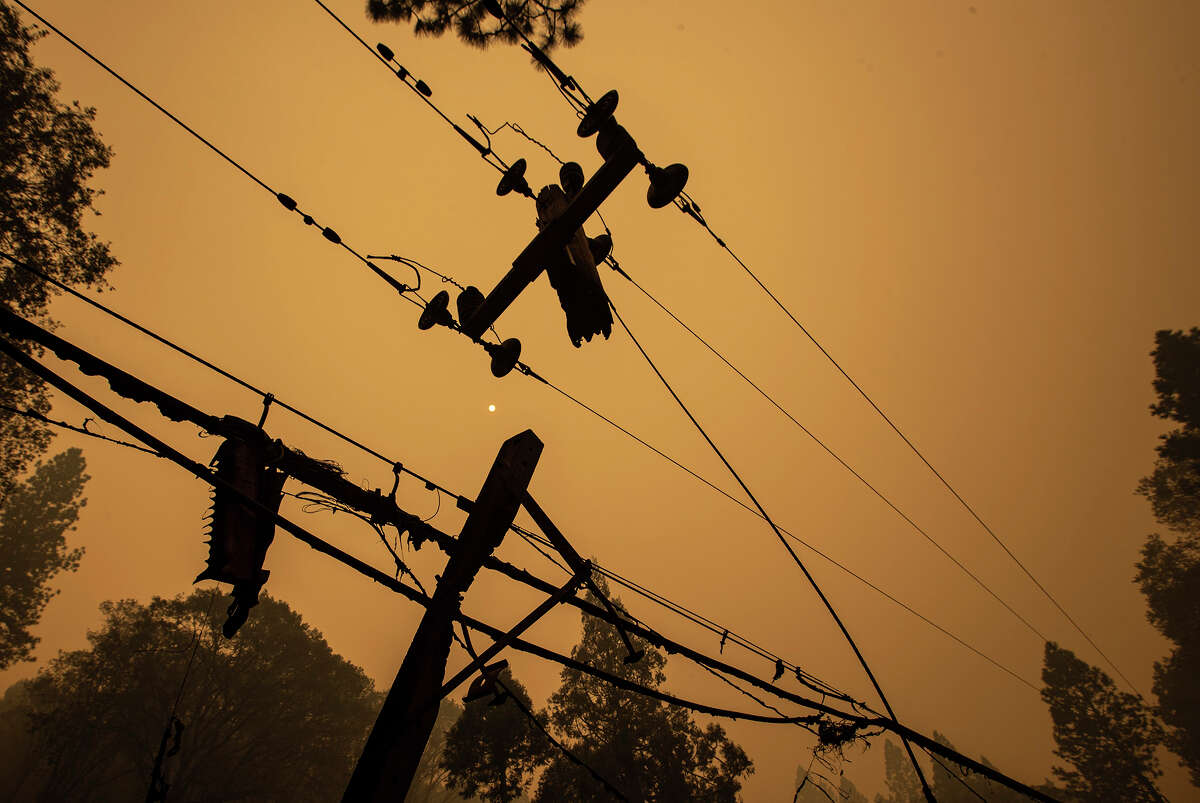 Burned utility poles and wires along Bald Rock Rd. in the North Complex fire on Friday, Sept. 11, 2020 in Berry Creek, CA.