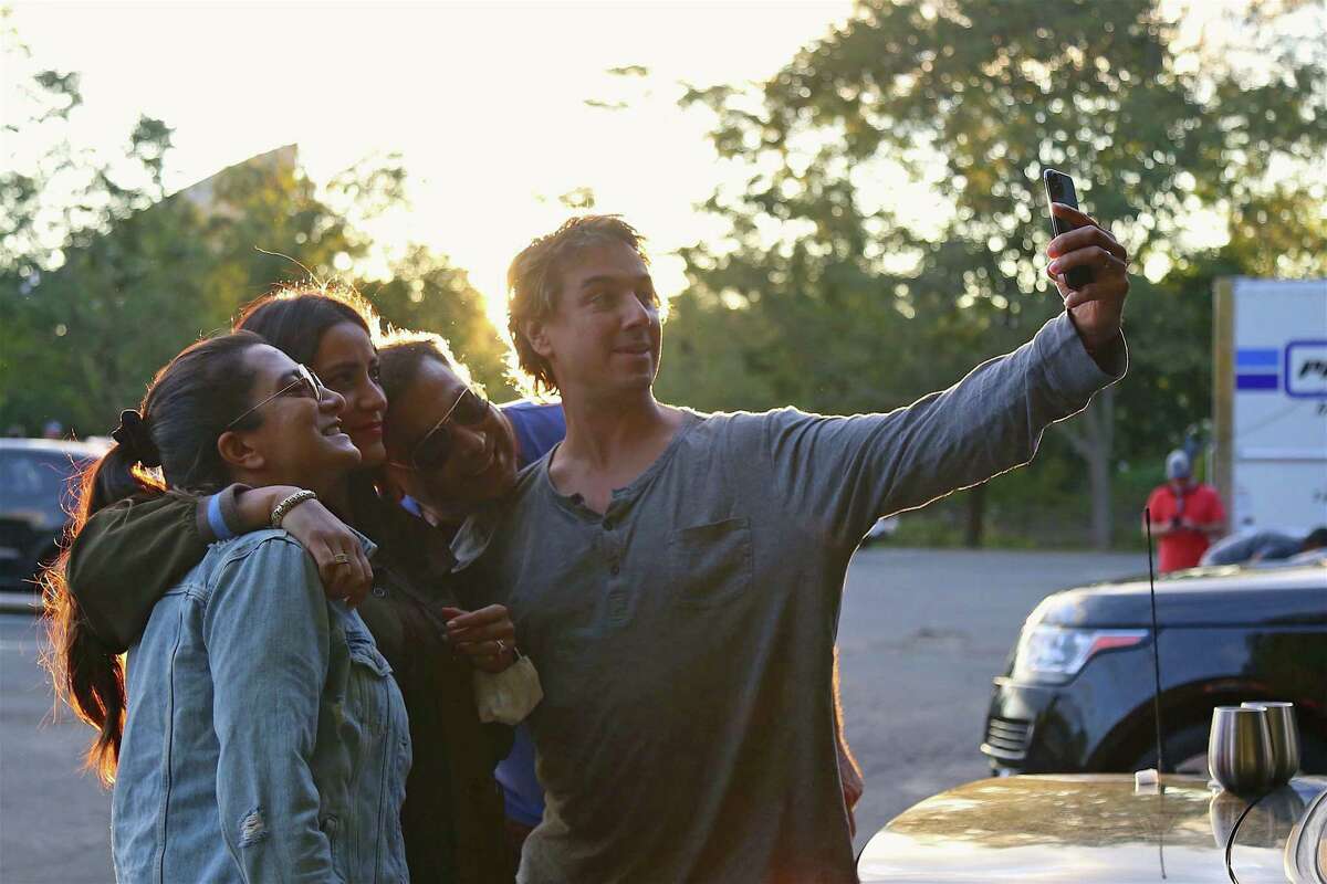 Friends grab a picture together, including, from left, Samreen Verma of Fairfield, Adriana Nassi of Norwalk, Rahul Verma, and David Nassi, at the Terrapin concert from the Supper & Soul series at the Imperial Lot on Friday, Sept. 11, 2020, in Westport, Conn. While last year the program was being held in the library's new main room, since the onset of the coronavirus and subsequent social distancing, the series has found a new and viable venue at the Imperial lot. Though there are only spaces for 70 cars, people are allowed to bring up to five visitors for the price of their ticket. "(They) did a great job in putting this together," Dunay noted, pleased and proud that the concert sold out in a matter of minutes after the group was announced.