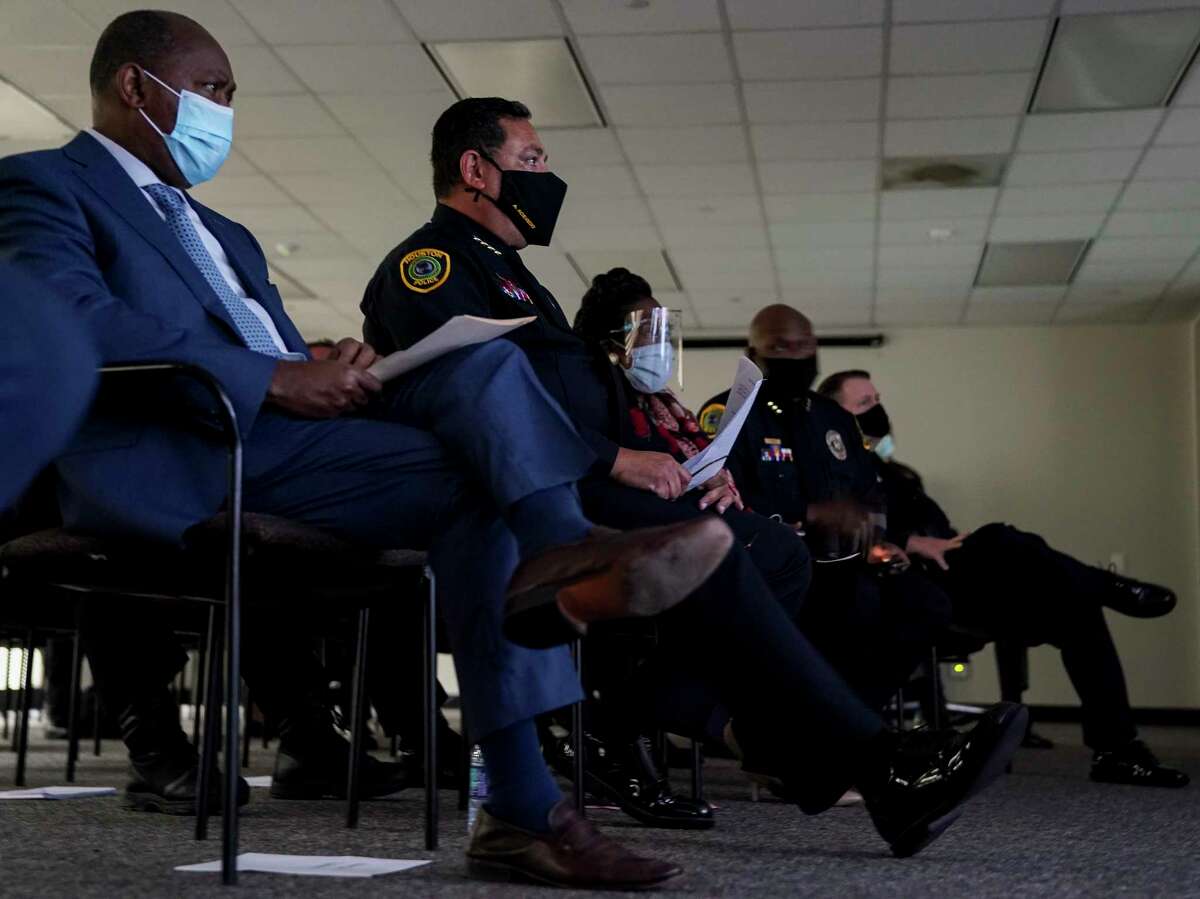 Mayor Sylvester Turner, left, and Houston Police Chief Art Acevedo watch the footage of the April 21 police shooting of Nicolas Chavez during a press conference last week. The city fired four officers for their roles in the shooting.