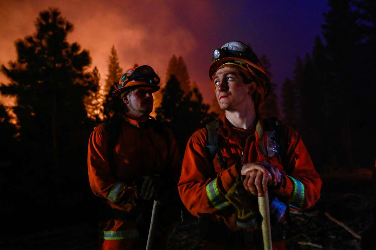 Valley View inmate firefighter Joshua Emerson - Merte waits for instruction before a backburn operation on the North Complex Fire in Butte County, California on Sunday, Sept. 13, 2020.