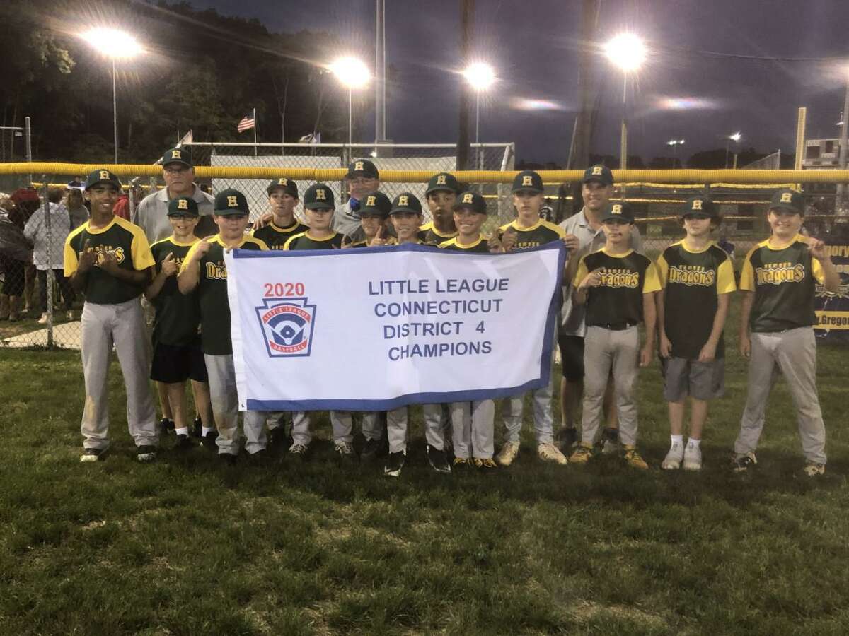 Members of the Hamden 12U Little League baseball team hold up the championship banner after winning the District 4 championship on Monday night.