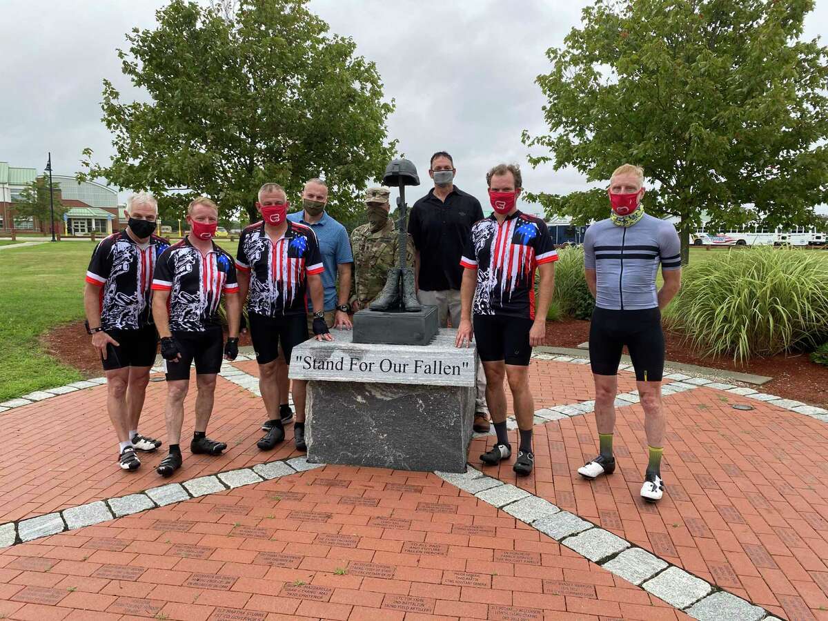 Colonel Charlie Anderson with a group of friends bicycle ride  to raise funds to create and install a granite memorial bench at Camp Nett.