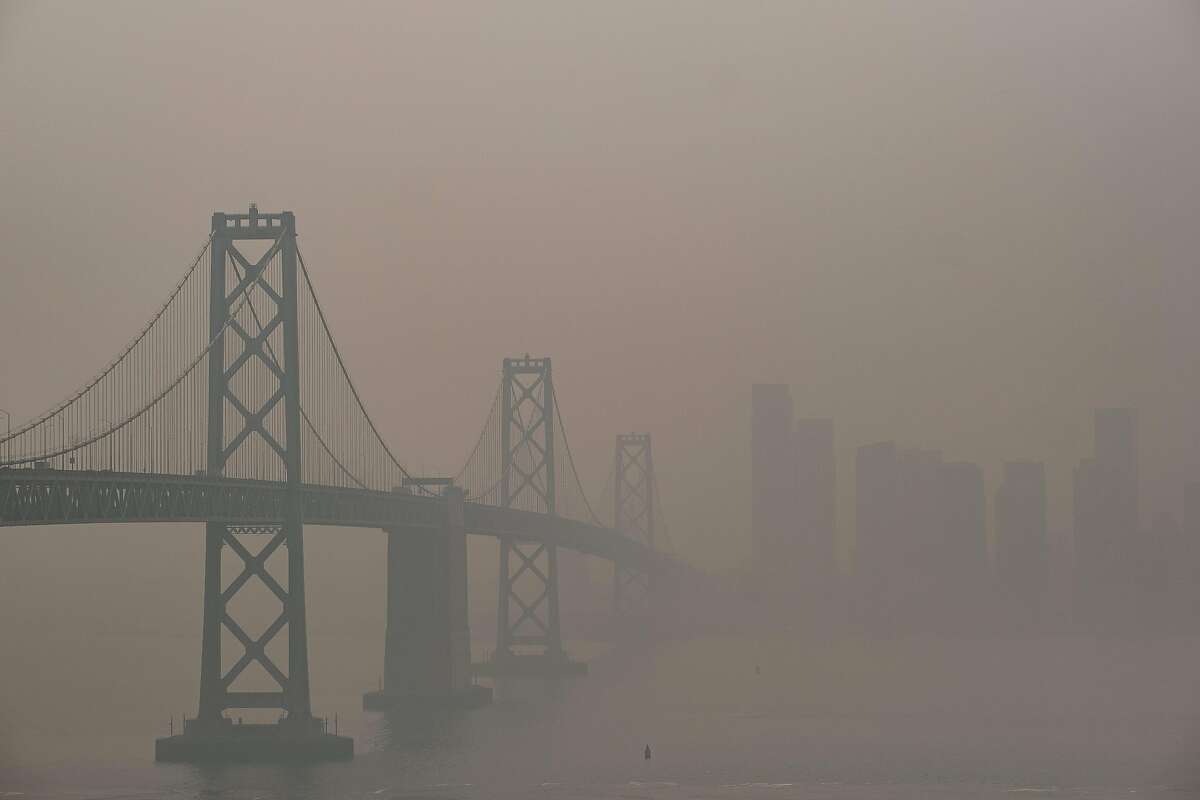 The Bay Bridge and San Francisco skyline are barely visible through the hazy smoke filled air fromTreasure Island, San Francisco on Friday, September 11, 2020. San Francisco continues to experience dangerous air quality due to the wildfires.