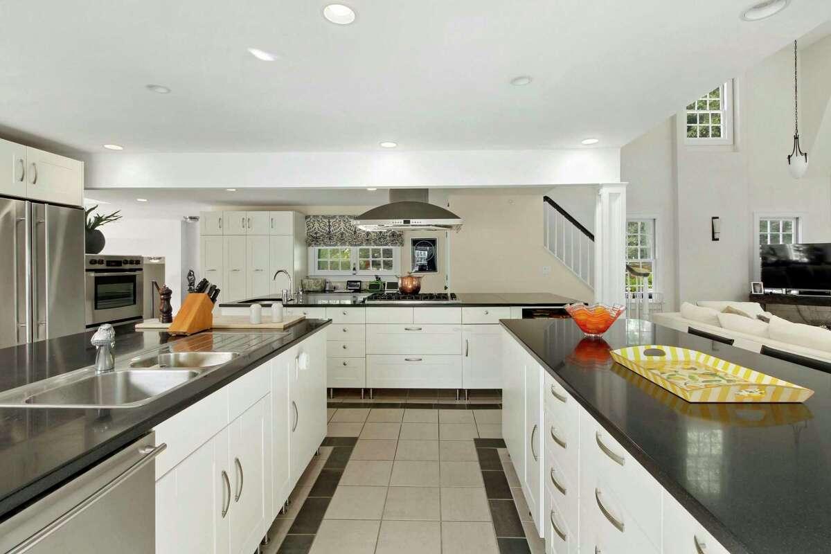 The gourmet eat-in kitchen features three large islands - one of which also serves as a breakfast bar, granite counters and high-end appliances. "Entertain in style and cook with pleasure in a large, chef-designed kitchen, adjoining the two-story family room/playroom loft," the agents said. This gourmet eat-in kitchen features three large islands - one of which also serves as a breakfast bar, granite counters and high-end appliances. The breakfast room has a deep tray ceiling with a contemporary lighting fixture, red brick flooring and a door to the patio and yard. In the family room there is a fireplace with a yellow brick surround. Upstairs, there are six bedrooms, all with en suite baths. There is also a passageway to the separate but attached guest cottage. The cottage has its own private entrance. Given the current health climate, should the state have to re-impose a lockdown or close schools again because of the COVID-19 pandemic, this could be a great set-up for remote working and a remote classroom.