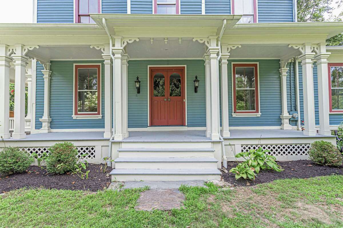 Although the paint color is different - now blue compared to the original white, the front entrance of this 12-room, 4,600-square-foot house has its original columns and French doors. Inside, there is