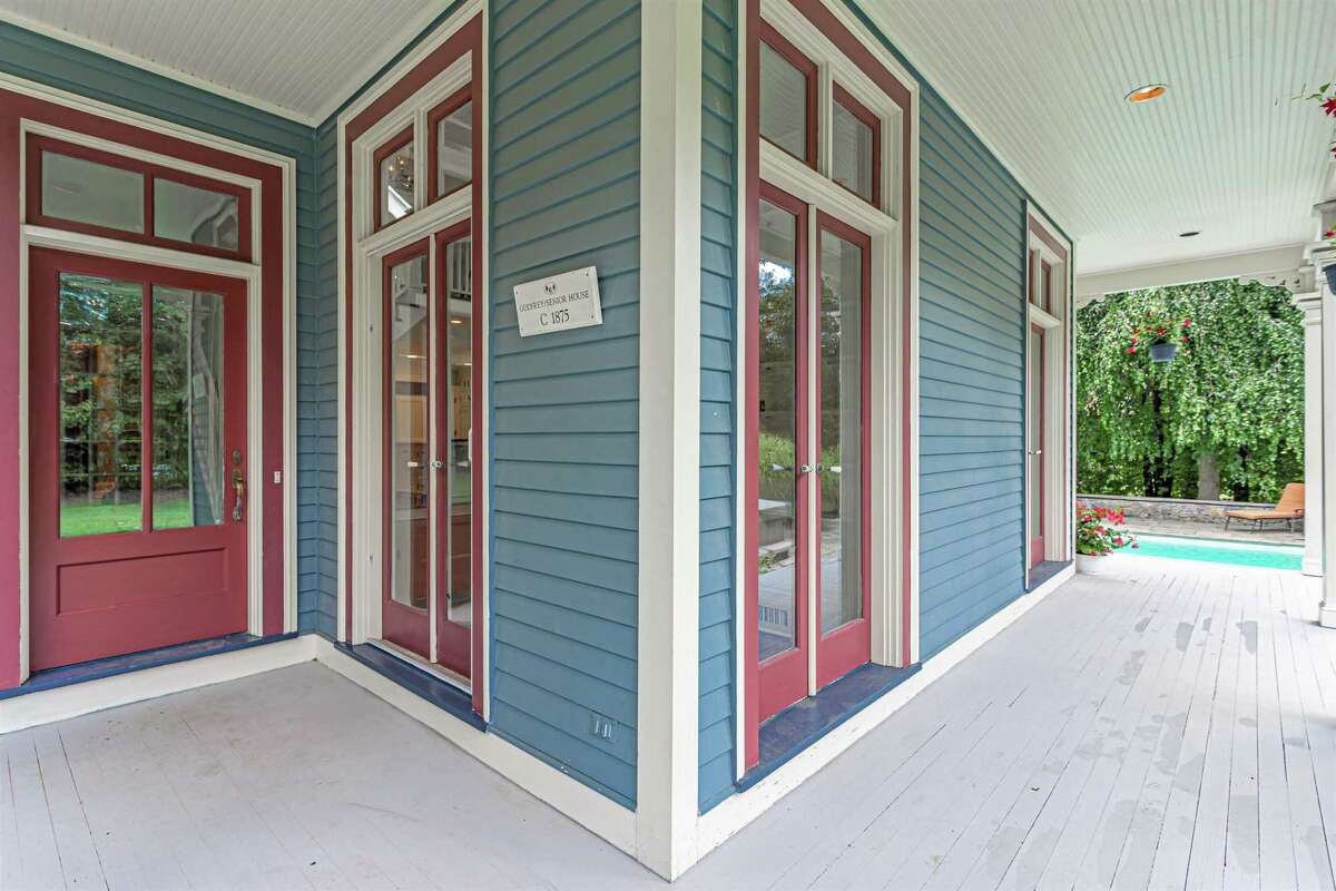 At the side entrance of this updated vintage house there is a plaque from the Easton Historical Society identifying it as the Godfrey/Senior House for its two most prominent residents. The family room is open to the chef's kitchen at the heart of the home. It has ample quartz countertops, decorative ceramic tile backsplash, and stainless steel appliances including a natural gas cooktop, double wall ovens and a Sub-Zero refrigerator. A column in the kitchen and another at the top of the staircase on the second floor resemble the ones on the porches.