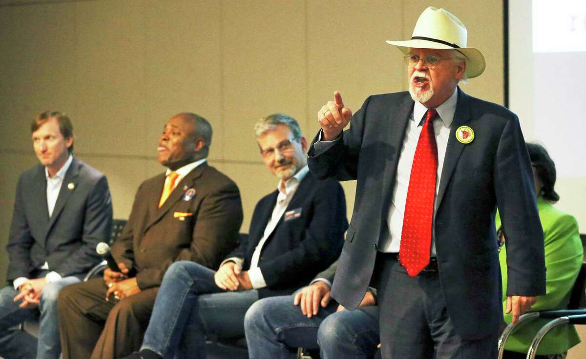 Tom Wakely shouts out his positions with out a microphone as Bexar County Democrat Chairman Manuel Medina hosts a gubernatorial candidate forum at the San Antonio Public Library on February 13, 2018.