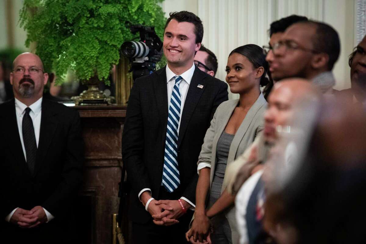 Charlie Kirk, center, and Candace Owens of Turning Point USA, listen to President Donald Trump speak in 2018.