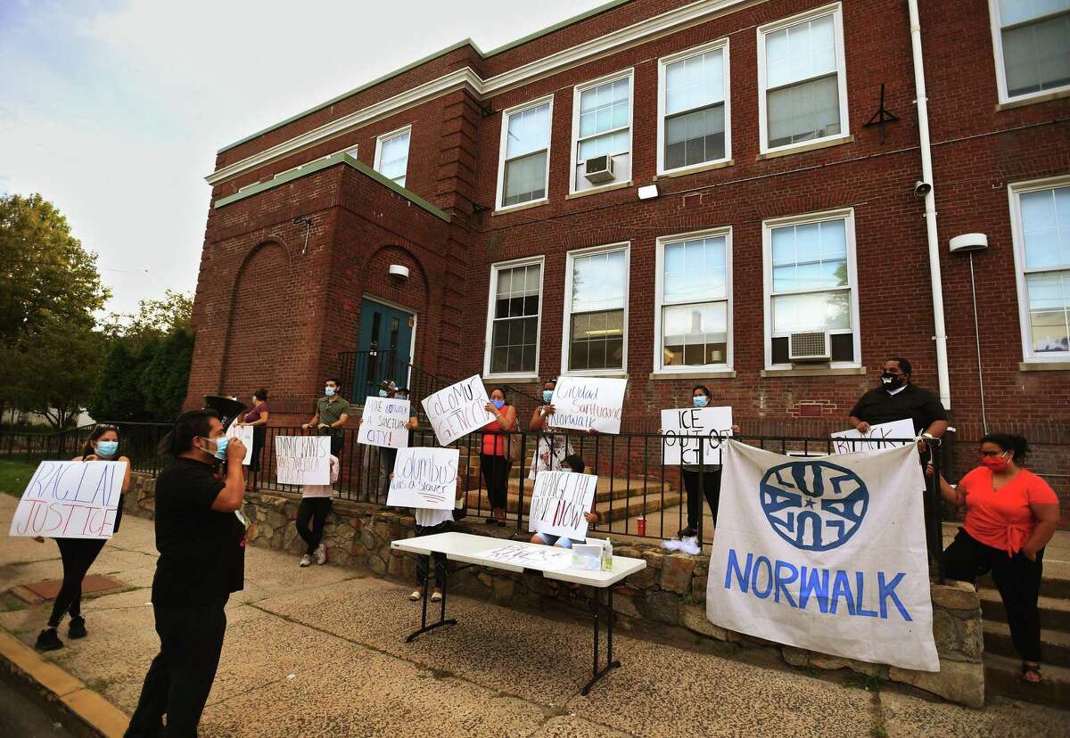 Members of the group Unidad Latina en Accion of Norwalk protest to change the name of Columbus Magnet School outside the school in Norwalk, Conn. on Monday, August 31, 2020. The group further advocated for the name change at a recent meeting of the Norwalk Board of Education.