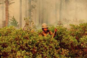 Firefighter Cody Carter battles the North Complex Fire in Plumas National Forest, Calif., on Monday, Sept. 14, 2020. (AP Photo/Noah Berger)