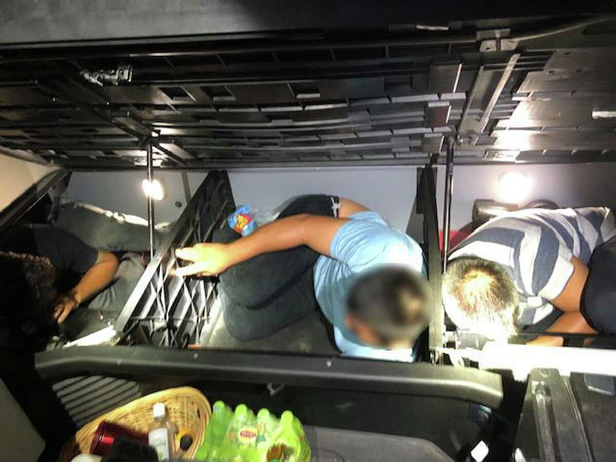 Immigrants are shown hiding in the bed of a truck that was stopped at the I-35 checkpoint.