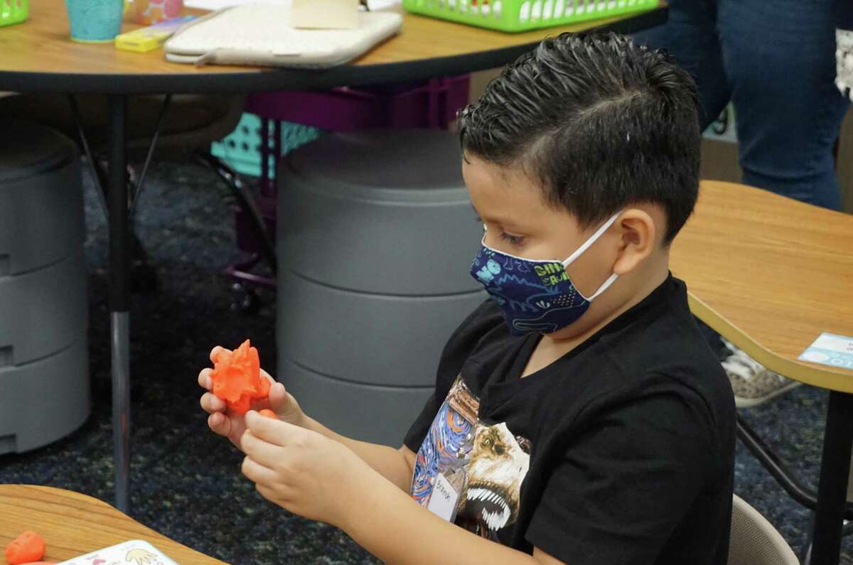 A McElwain Elementary student works some play dough on the first day of in-person instruction for Katy Independent School District, Tuesday, Sept. 8.