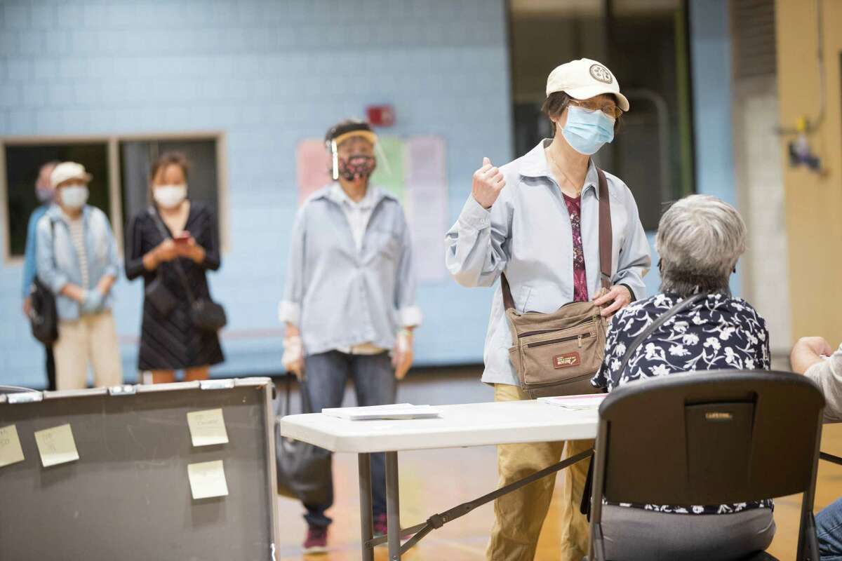 Voters wore protective masks and practiced social distancing in Boston, Mass. earlier this month. Soon, many of us will have to vote safely during the pandemic. It can be done.