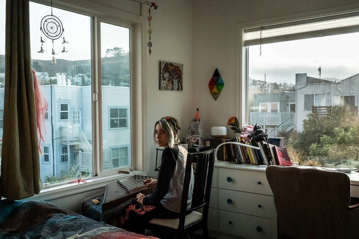 Ninoa Kanangar plays a santur in her room at the Manor of Being House on Tuesday, Sept. 15, 2020 in San Francisco, Calif. Eleven international people share the home with occupations that includes tech, mathematics, music and art.