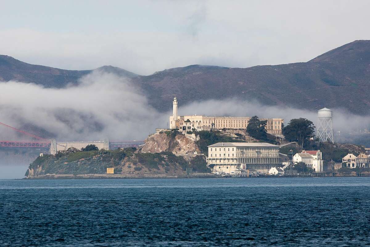 Alcatraz Island sits in a layer of fog under blue skies seen from Treasure Island in San Francisco, September 16, 2020.