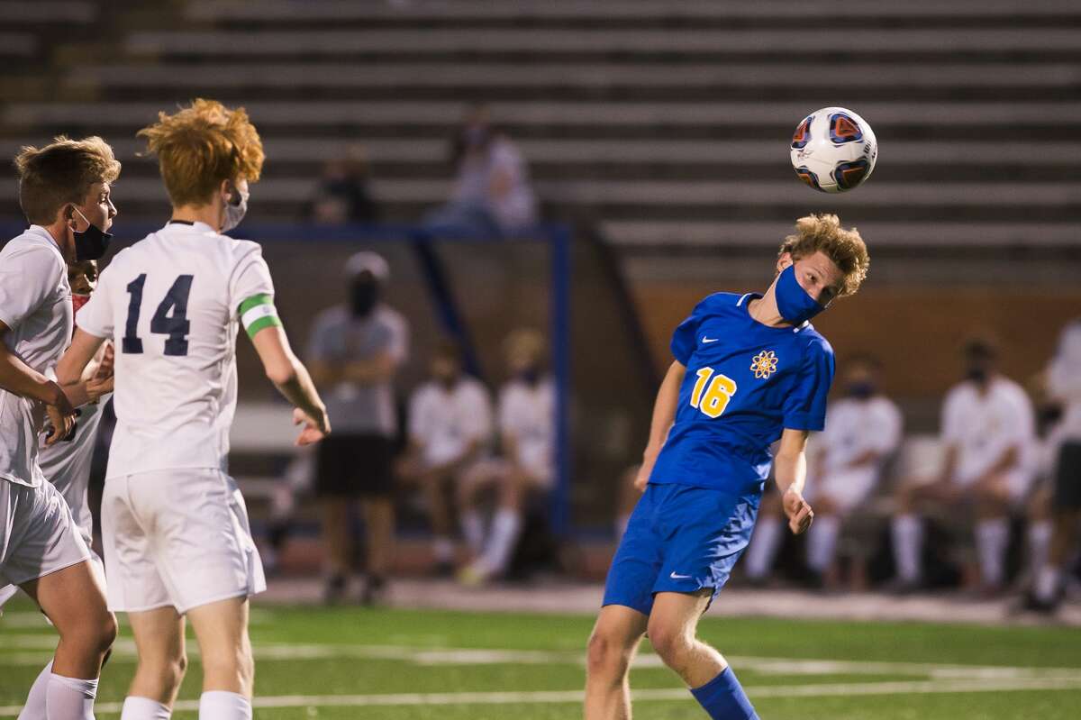 Midland's Robert Perry jumps up for a header during a game against Mount Pleasant Wednesday, Sept. 16, 2020 at Midland Community Stadium. (Katy Kildee/kkildee@mdn.net)