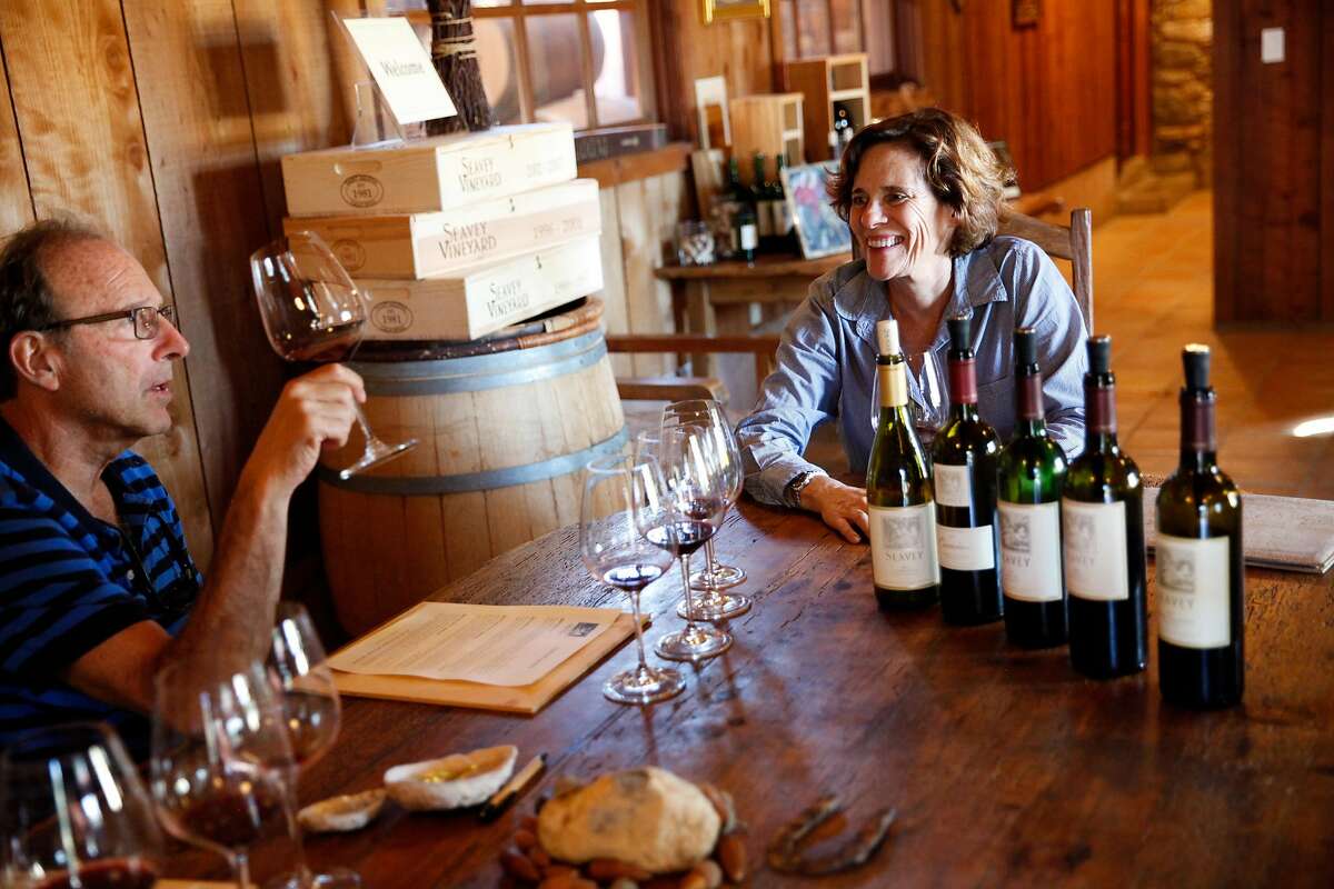 Dorie Seavey, right, talks to Paul Osterman, of Boston, as he tries her wines in the tasting room at Seavey Vineyard in St. Helena, Calif., on Monday, October 12, 2015.
