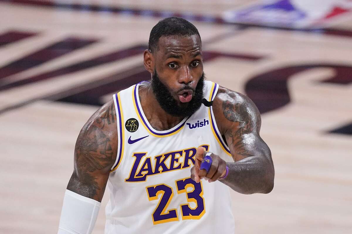 Los Angeles Lakers' LeBron James (23) signals during the second half of an NBA conference semifinal playoff basketball game against the Houston Rockets Saturday, Sept. 12, 2020, in Lake Buena Vista, Fla. (AP Photo/Mark J. Terrill)
