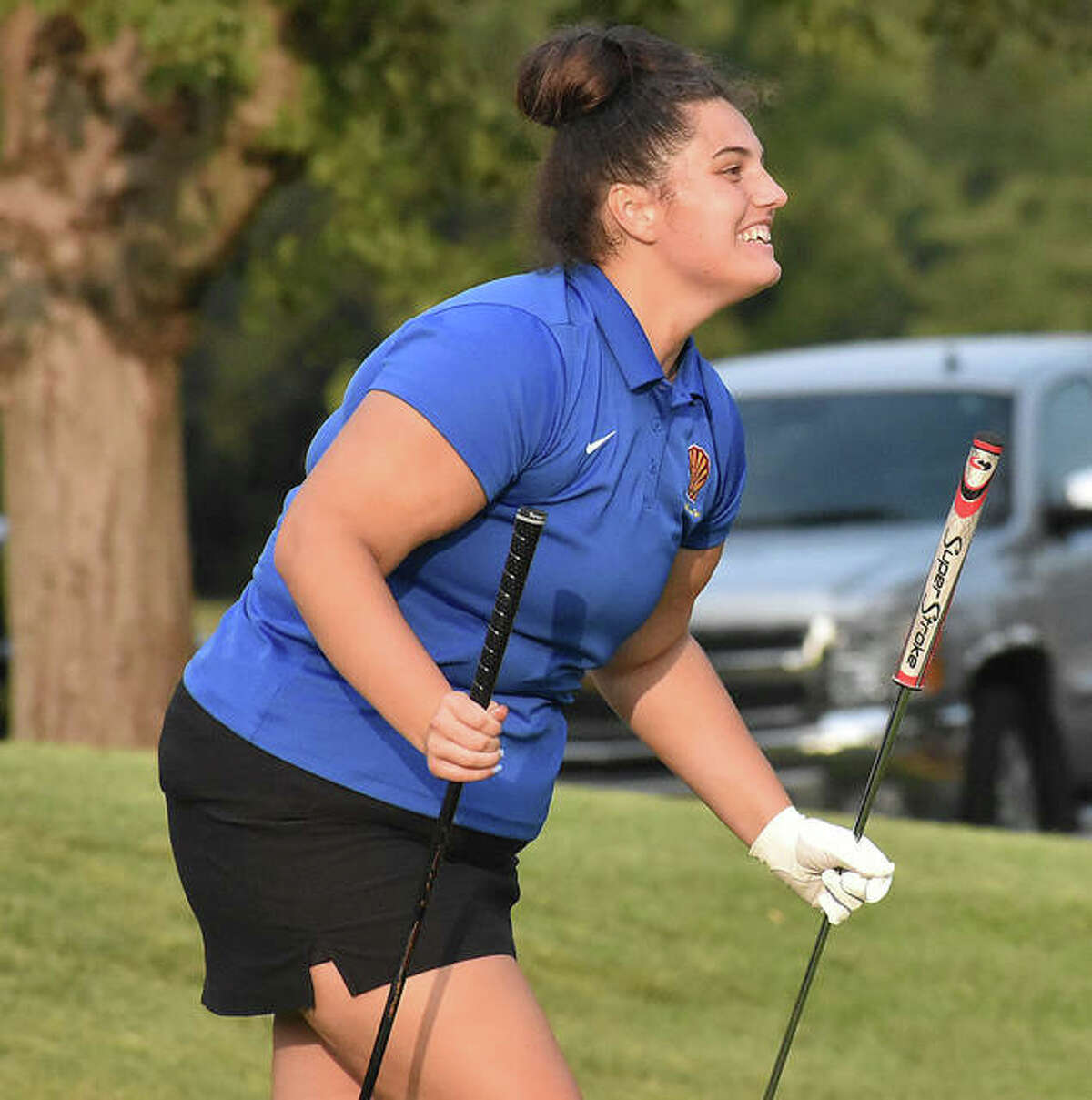 Roxana’s Sarah Floyd took two clubs to the ninth green at Spencer T. Olin golf course on Wednesday, but she didn’t need the putter after chipping in for birdie. She reacts while walking to the cup after leading the Shells with a 46.