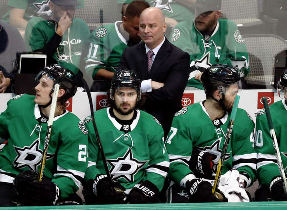 Dallas Stars coach Jim Montgomery, center rear, watches play against the Nashville Predators during the third period of Game 4 in an NHL hockey first-round playoff series in Dallas. The Blues have hired Jim Montgomery as an assistant 10 months after he was fired as coach of the Dallas Stars for unprofessional conduct.