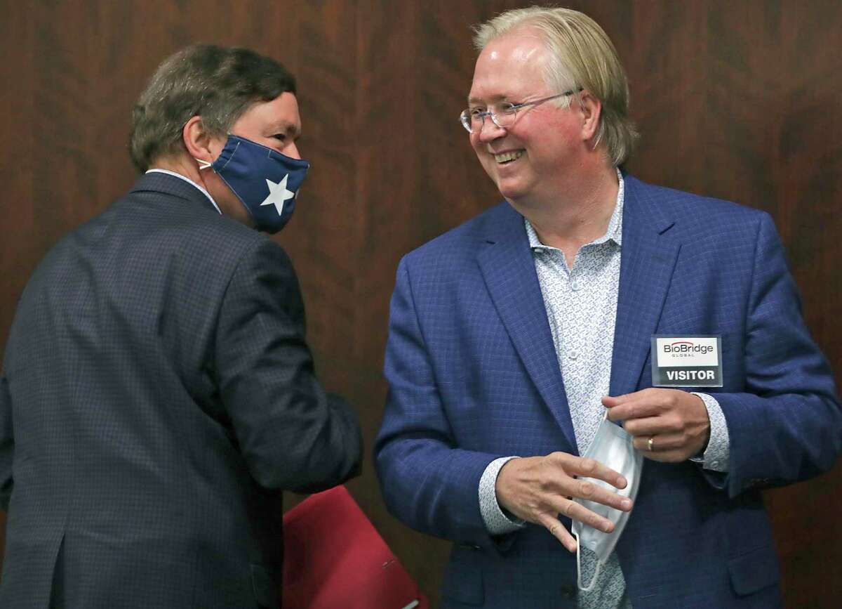 Graham Weston, right, chairman of Community Labs, bumps elbows with J. Bruce Bugg Jr., vice chairman of Community Labs, in September. The nonprofit was established to provide coronavirus tests to the San Antonio community.