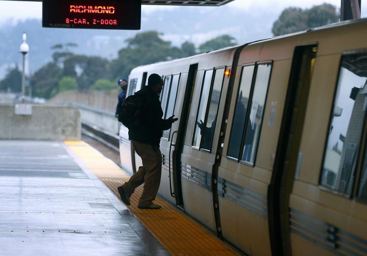 A passenger boards a Richmond train at the MacArthur BART station in Oakland, Calif. on Tuesday, May 12, 2020. BART is joining transit agencies from around the country in seeking economic federal relief funds because of dwindling ridership during the coronavirus shutdown.