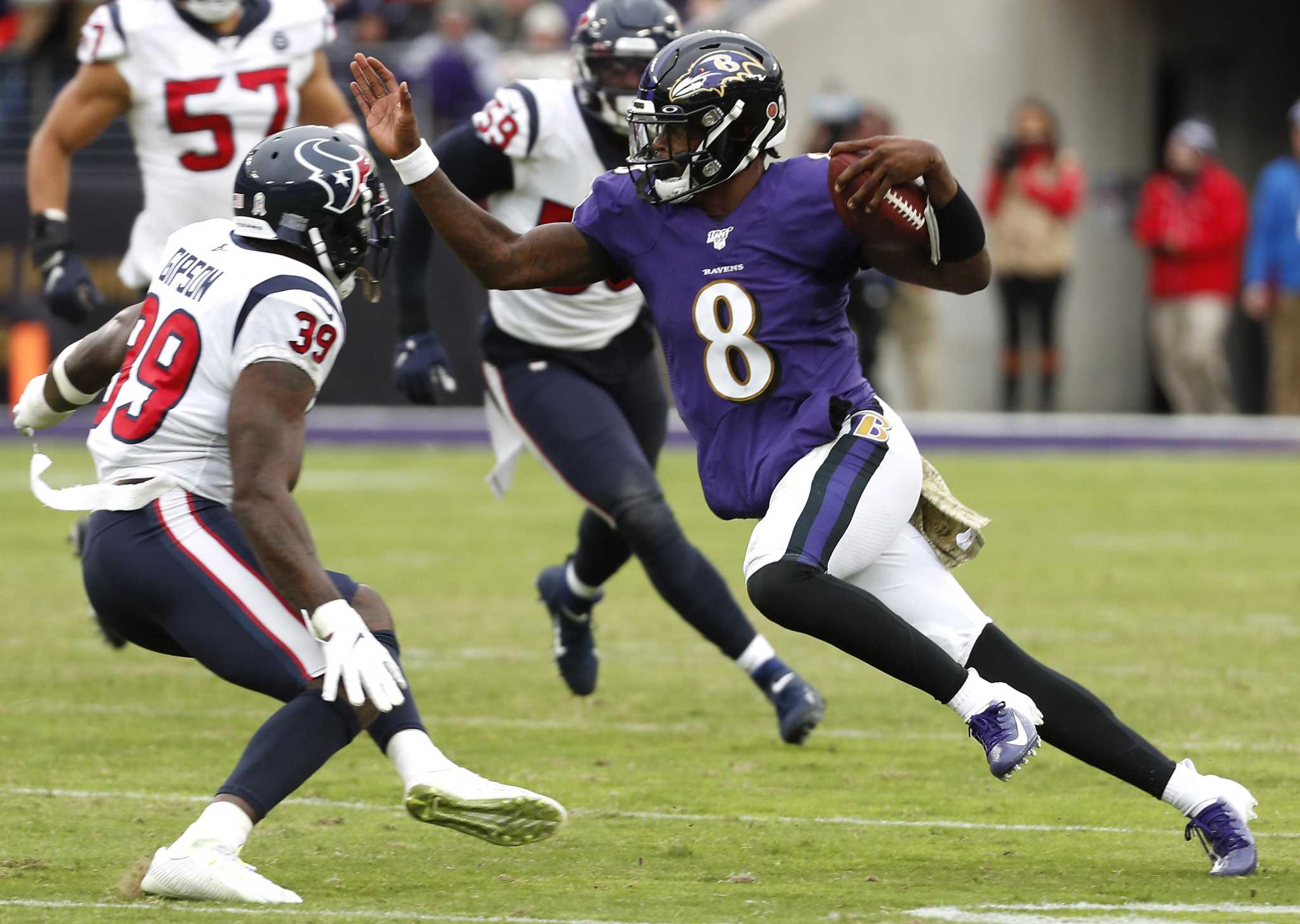 Baltimore Ravens running back J.K. Dobbins (27) takes a handoff from  quarterback Lamar Jackson …