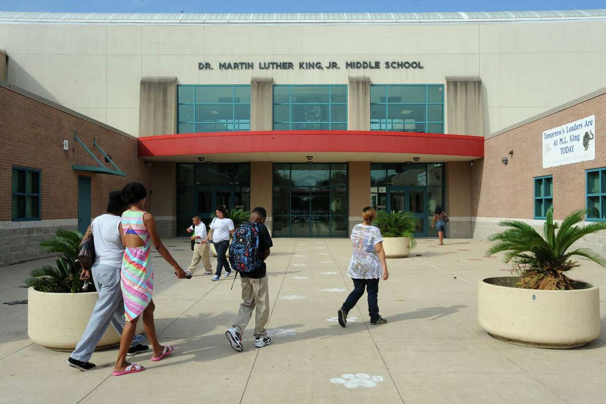 Several parents walked their children to he first day of classes at Martin Luther King Junior High in Beaumont on Monday. Monday marked the first day that Austin Middle School students merged with MLK. Photo taken Monday, August 25, 2014 Guiseppe Barranco/@spotnewsshooter