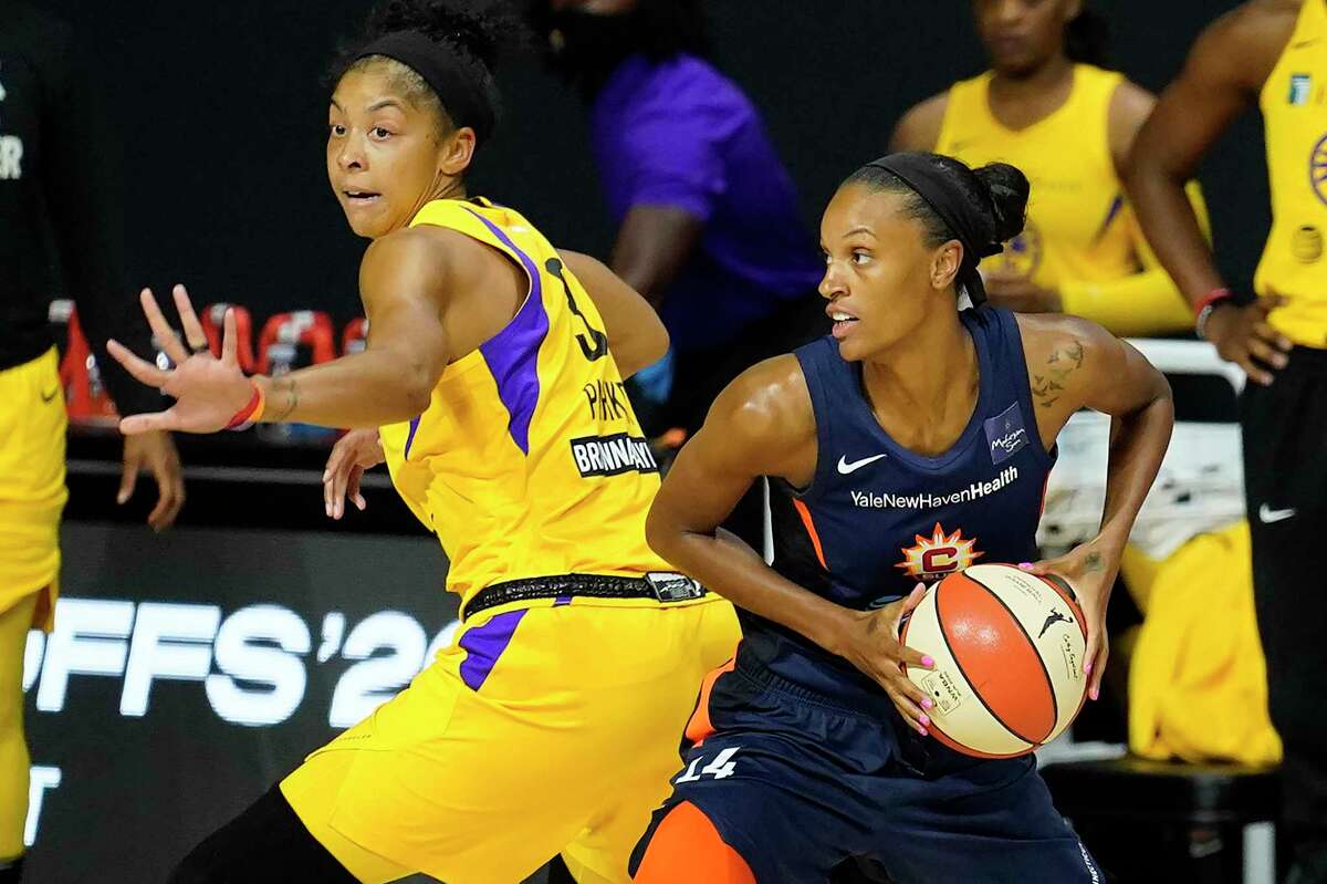 Connecticut Sun forward DeWanna Bonner, right, looks to pass around Los Angeles Sparks forward Candace Parker during the first half of a WNBA playoff basketball game on Thursday in Bradenton, Fla. Bonner had 17 points and 13 rebounds in the Sun’s 73-57 win.