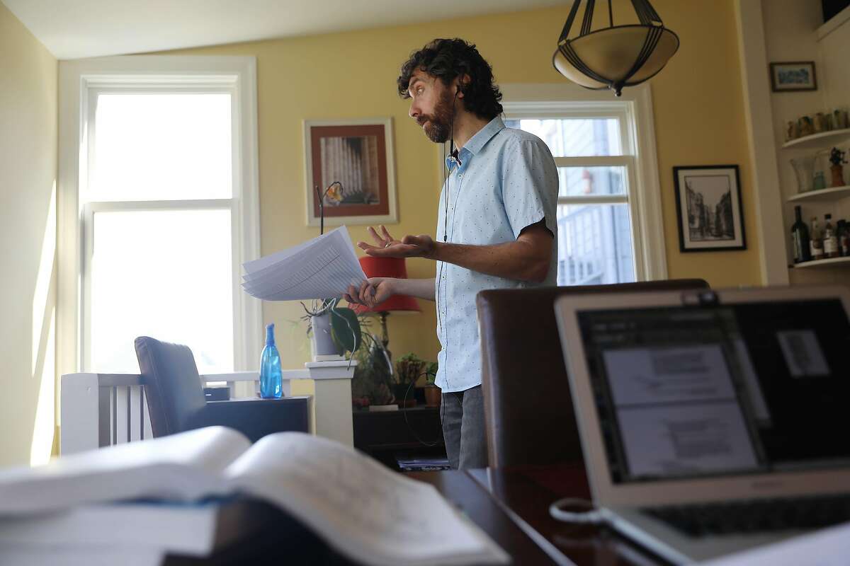 Daniel Schweitzer, state bar tutor, carries papers and gestures as he talks to a client during a tutoring session from his home on Wednesday, September 16, 2020 in San Francisco, Calif.